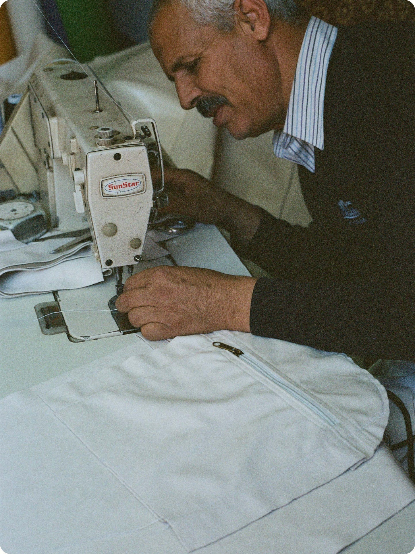 A moroccan artisan tailoring our classic 'Away' Weekender