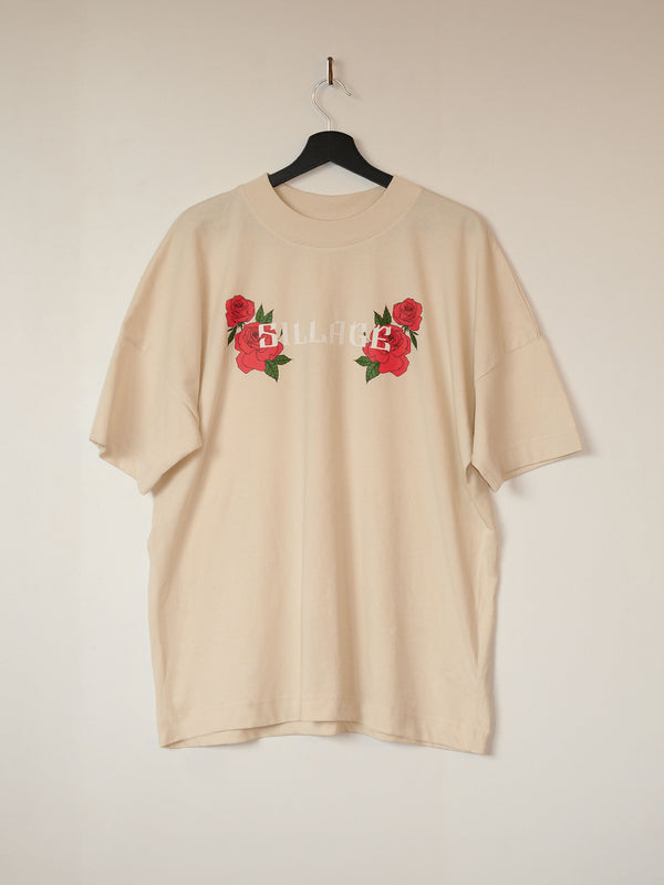 a cream white oversized t-shirt with two roses on each side of the white sillage logo front print.